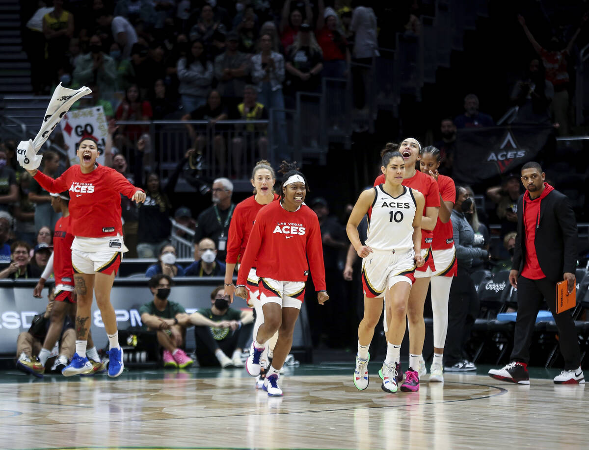 The Las Vegas Aces, including guard Kelsey Plum (10), react as time expires and they defeat the ...
