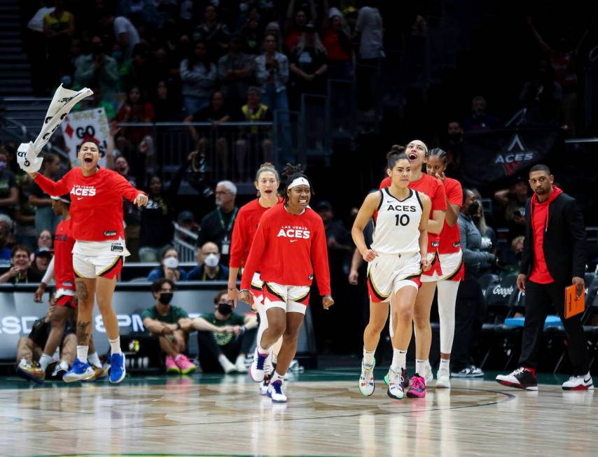 The Las Vegas Aces, including guard Kelsey Plum (10), react as time expires and they defeat the ...