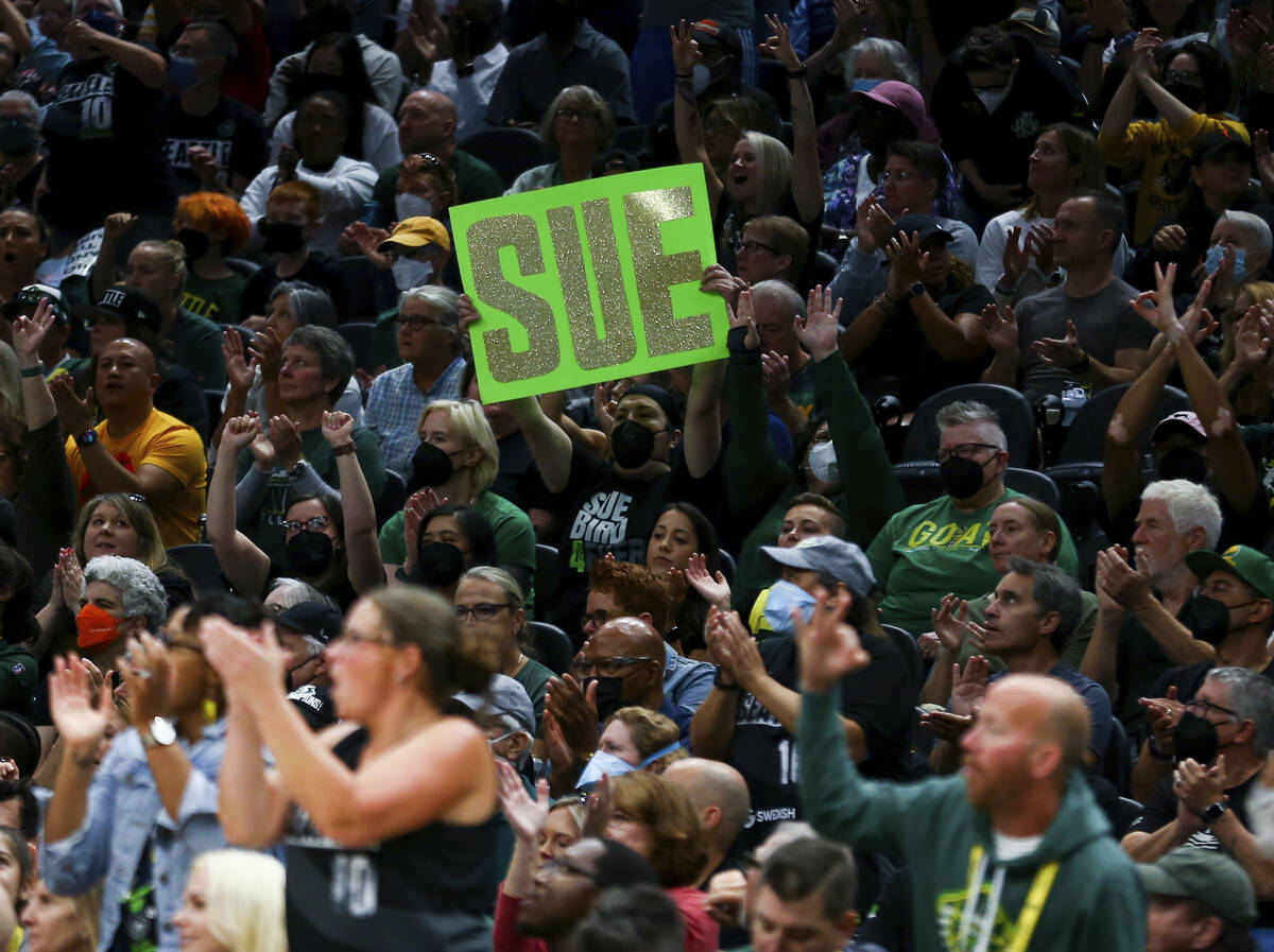 A Seattle Storm fan holds a "SUE" sign during the first half in Game 3 of a WNBA bask ...