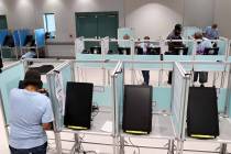FILE - Clark County election workers set up voting booths at the Cora Coleman Senior Center in ...