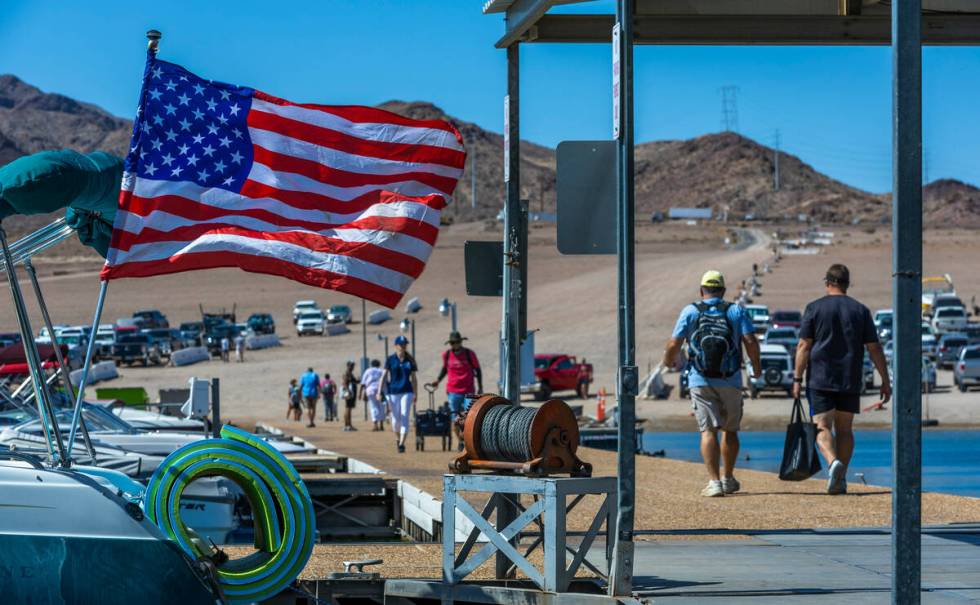 Visitors walk along the dock at the Lake Mead Marina on Labor Day within the Lake Mead National ...