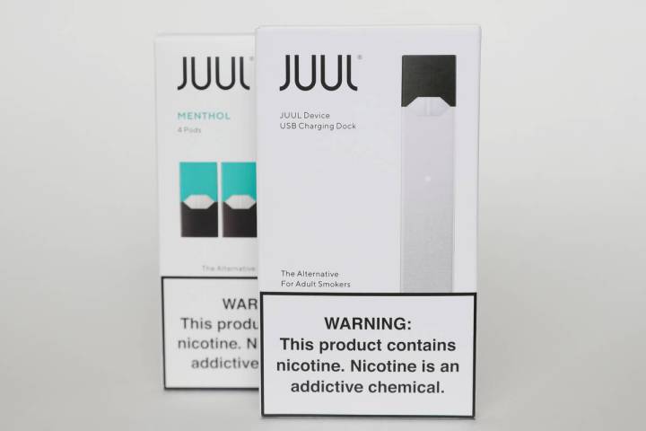 FILE - Packaging for an electronic cigarette and menthol pods from Juul Labs is displayed on Fe ...