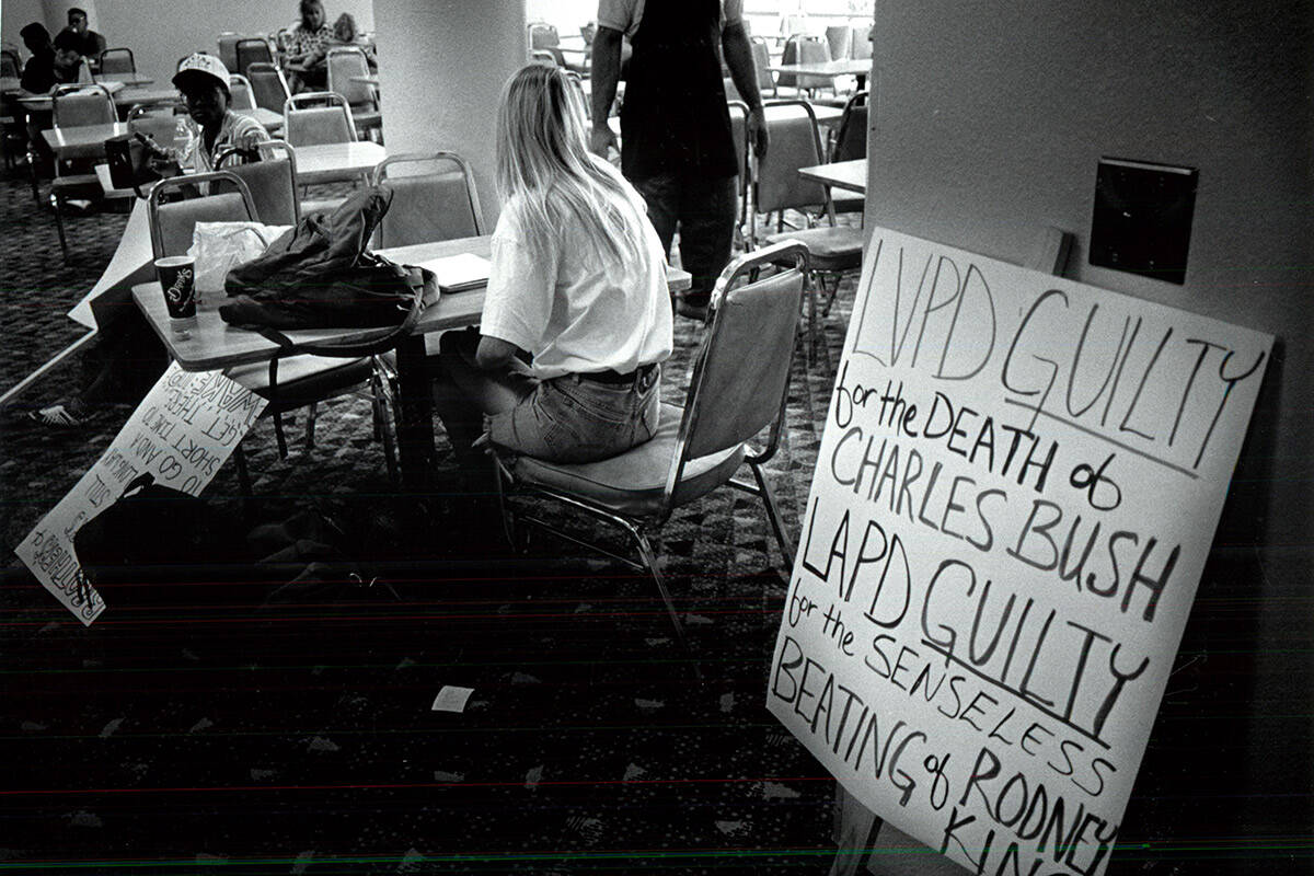Students display signs protesting the Los Angeles Police Department during the Rodney King riot ...