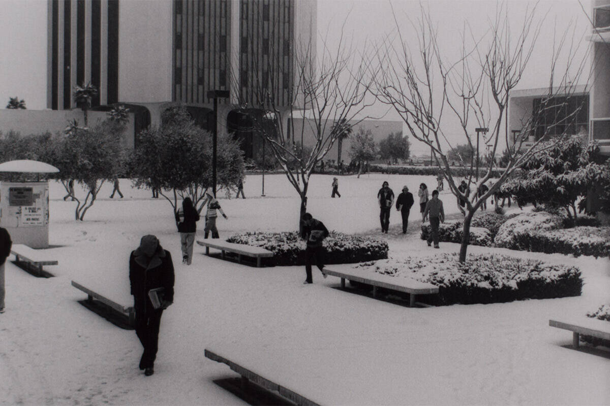 A view of students walking around campus during snowfall at the University of Nevada, Las Vegas ...