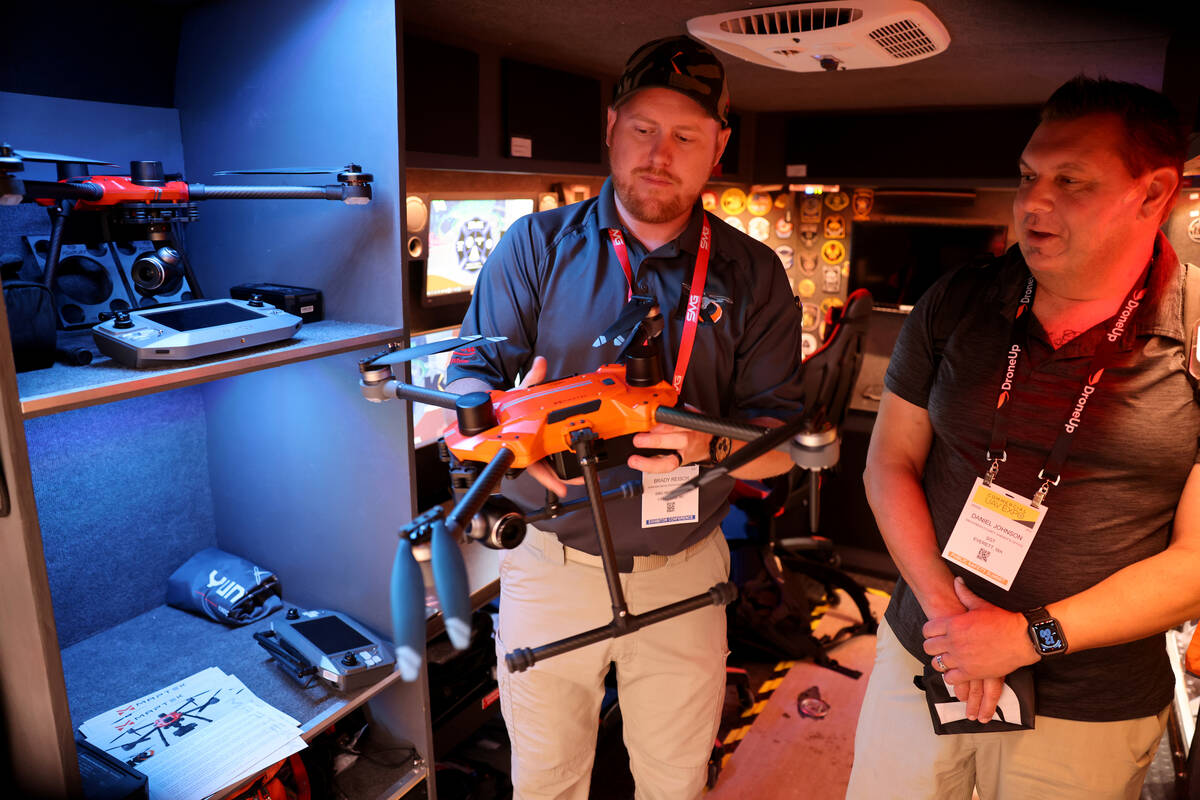 FILE -Brady Reisch of Sundance Media Group, left, shows a drone to Daniel Johnson with the Snoh ...