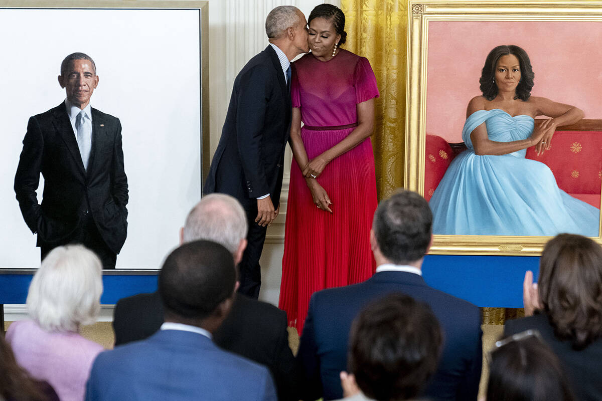Former President Barack Obama kisses his wife former first lady Michelle Obama after they unvei ...