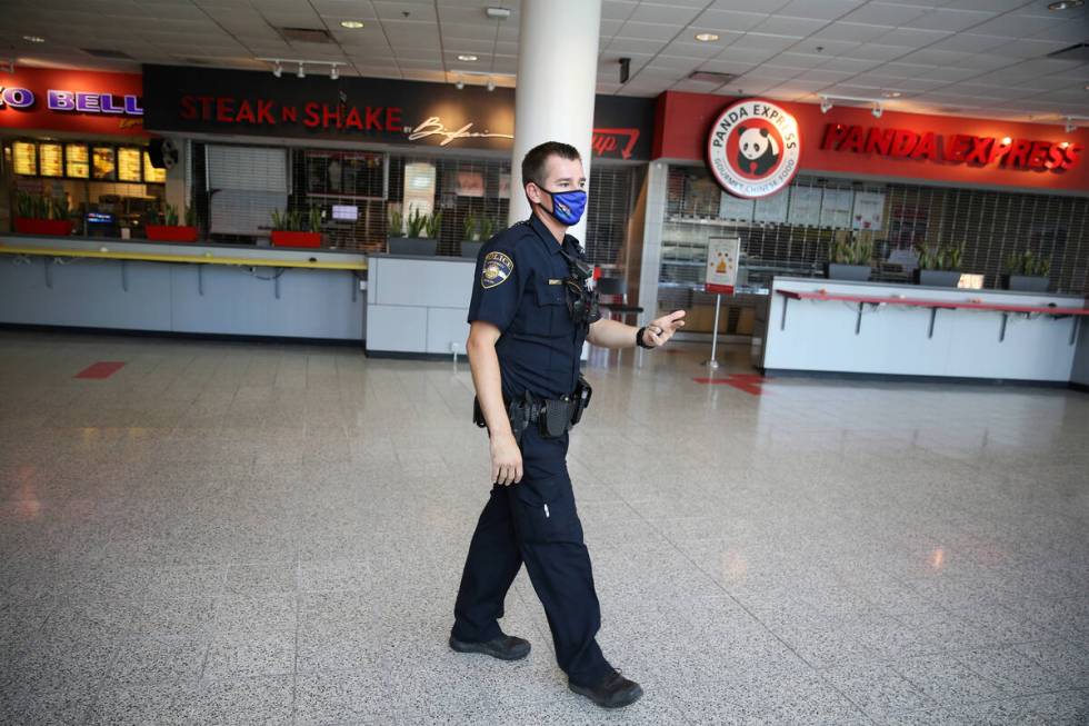 FILE - University Police Department officer Ryan Willman patrols the UNLV campus on foot in Las ...