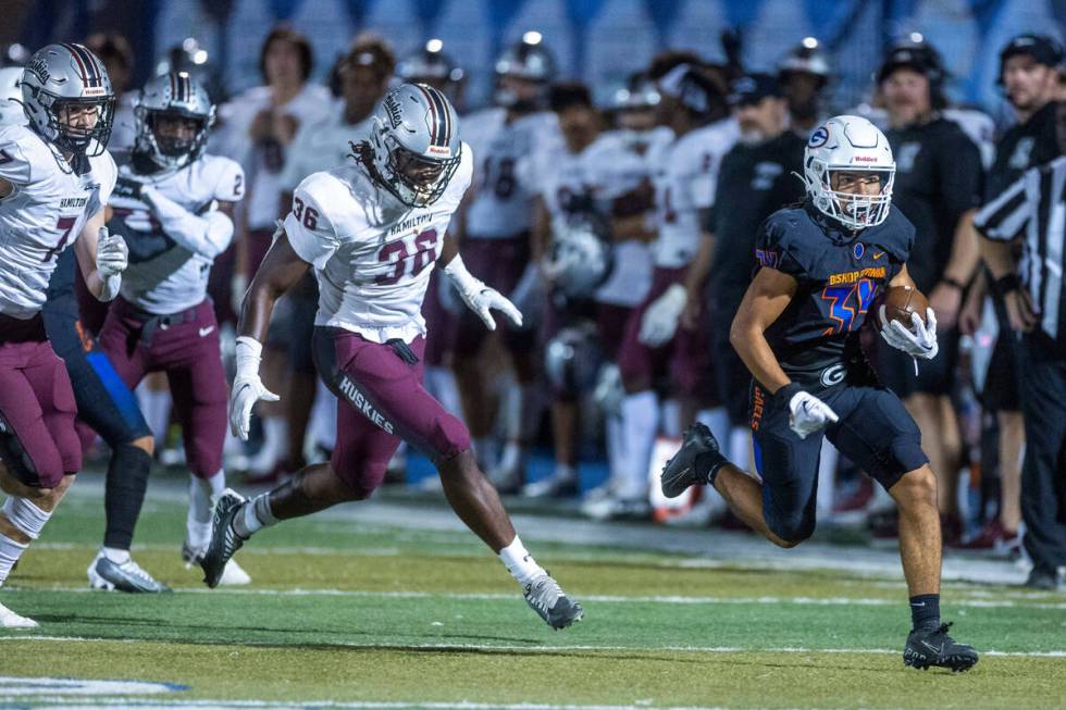 Bishop Gorman running back Myles Norman (34) heads towards the end zone pursued by Hamilton lin ...