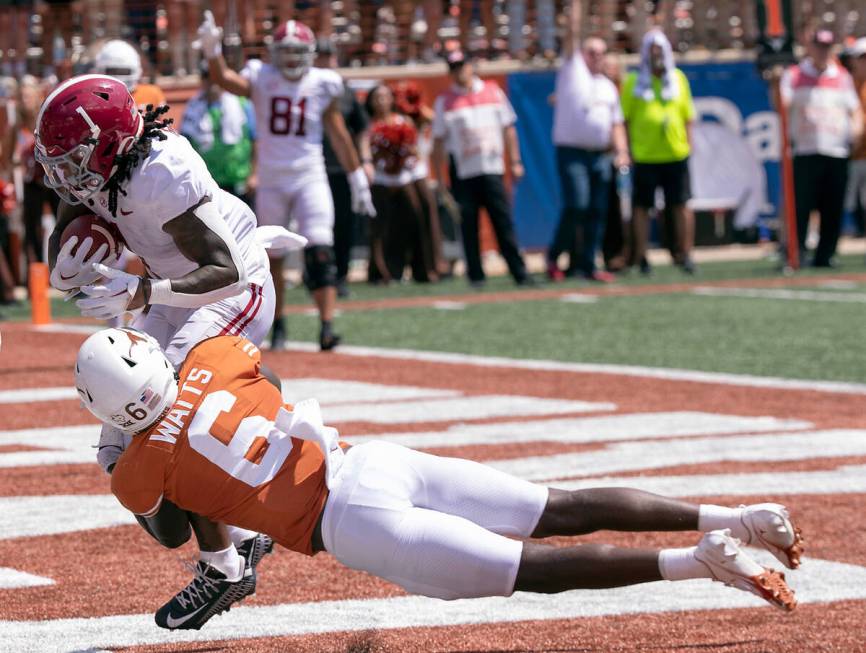 Alabama running back Jahmyr Gibbs catches a touch down reception as Texas defensive back Ryan W ...