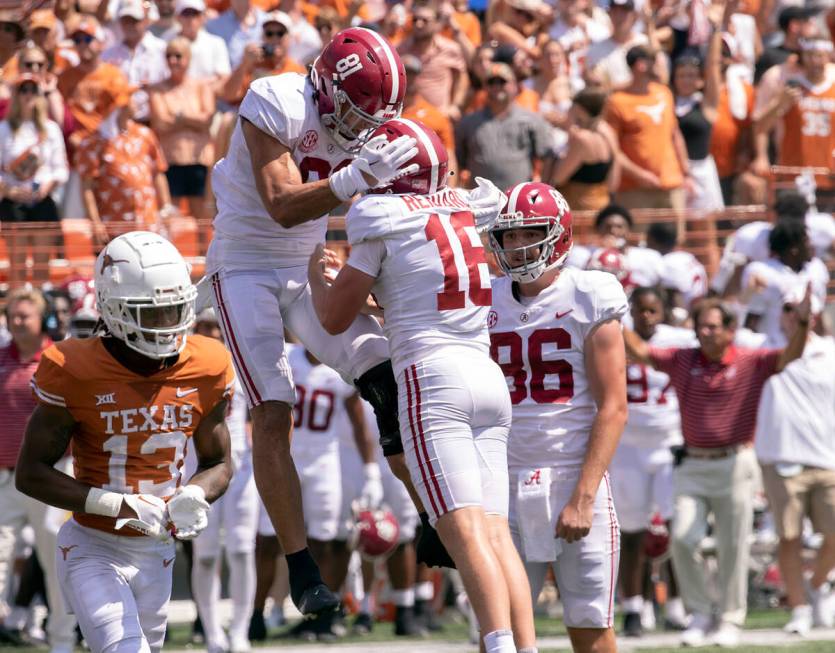 Alabama tight end Cameron Latu (81) celebrates with place kicker Will Reichard and James Burnip ...