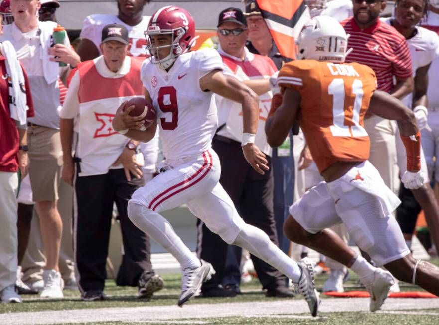 Alabama quarterback Bryce Young (9) is chased out of bounds by Texas defensive back Anthony Coo ...