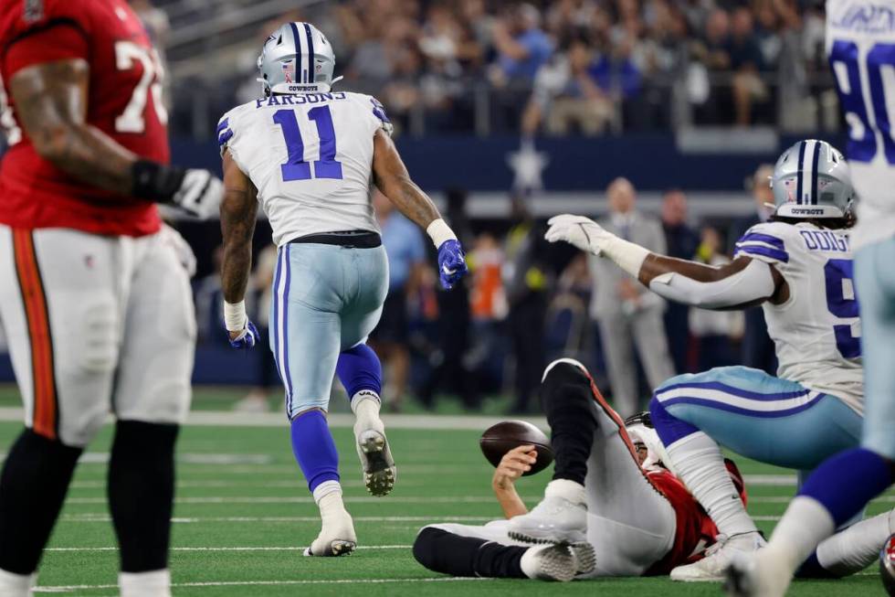 Dallas Cowboys linebacker Micah Parsons (11) runs up field celebrating after sacking Tampa Bay ...