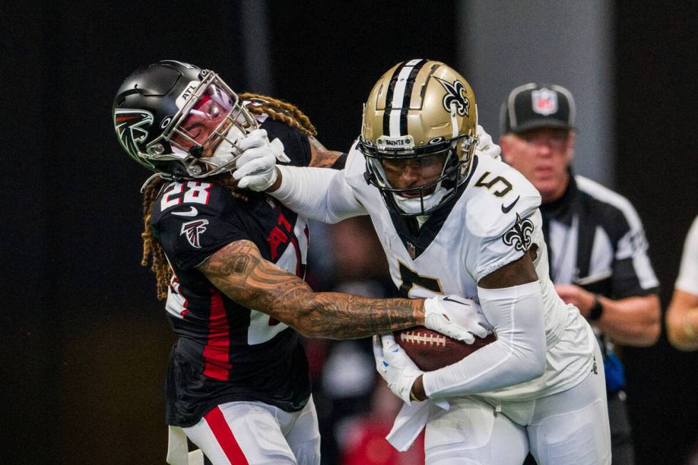 New Orleans Saints wide receiver Jarvis Landry (5) stiff arms Atlanta Falcons cornerback Mike F ...