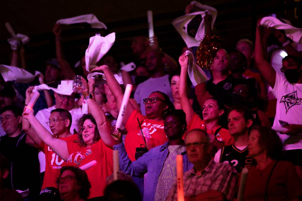 Las Vegas Aces fans wave their team towels during the second half in Game 1 of a WNBA basketbal ...