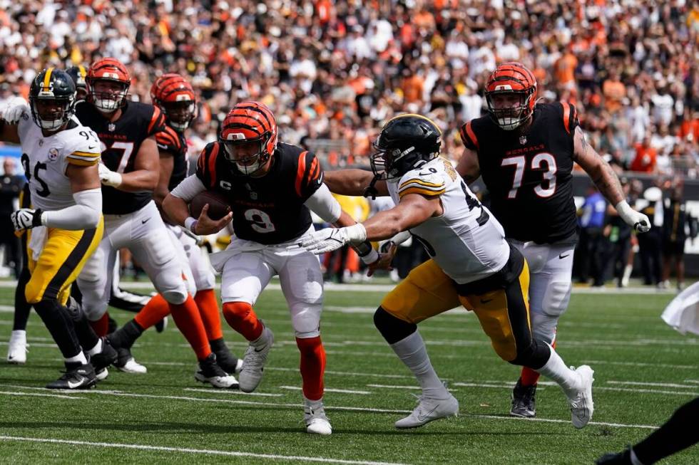 Cincinnati Bengals quarterback Joe Burrow (9) is tackled by Pittsburgh Steelers linebacker Alex ...