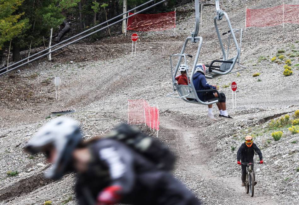 Bicyclists ride down a path at the downhill mountain bike park at Lee Canyon resort in Las Vega ...