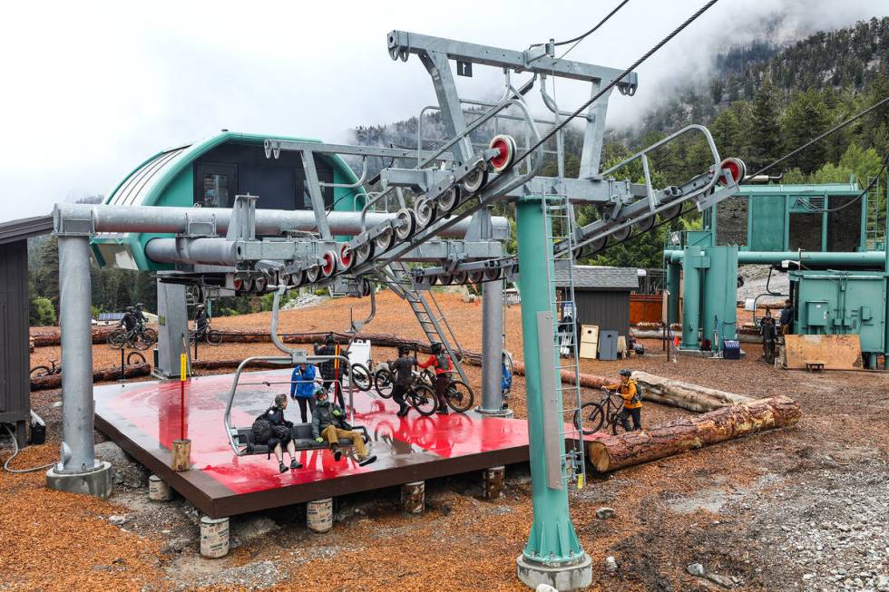 Bicyclists wait to take the ski lift up the mountain at the downhill mountain bike park at Lee ...