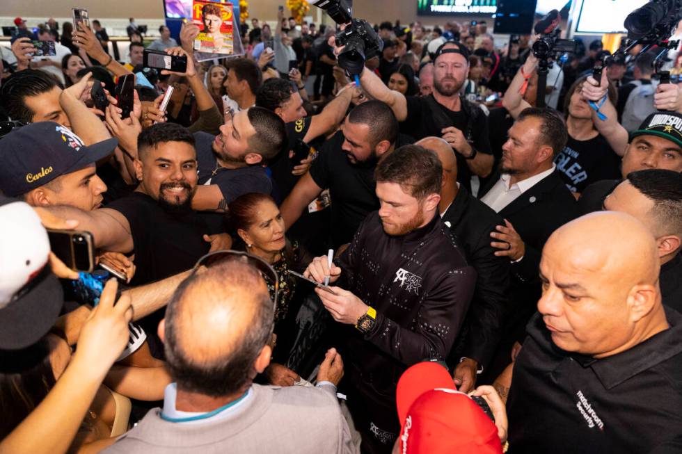 Saul "Canelo" Alvarez, right, signs autographs for fans during the "grand arriva ...