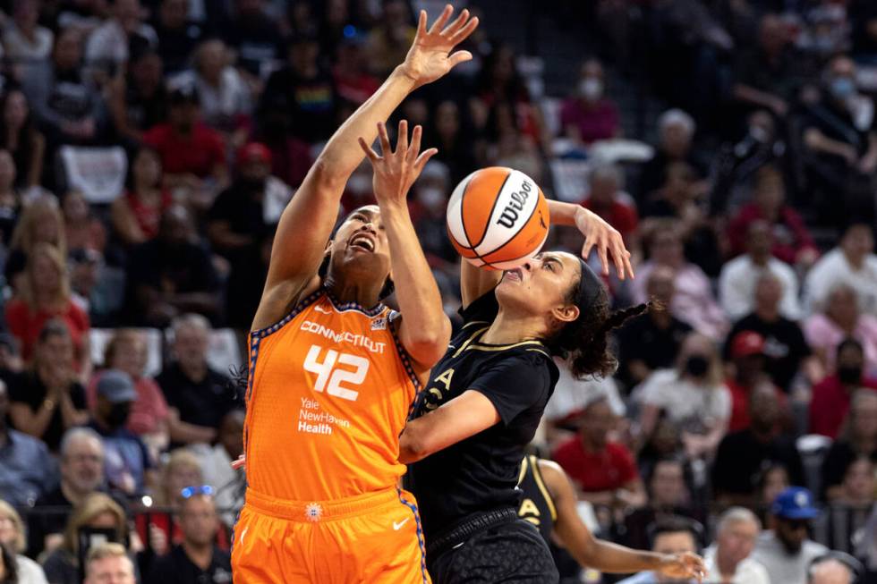 Las Vegas Aces forward Dearica Hamby (5) knocks a shot way from Connecticut Sun center Brionna ...