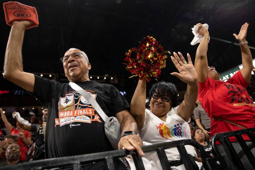 Las Vegas Aces fans Melvin Stringer, left, Verna Stringer and Tamu Lee cheer after their team s ...