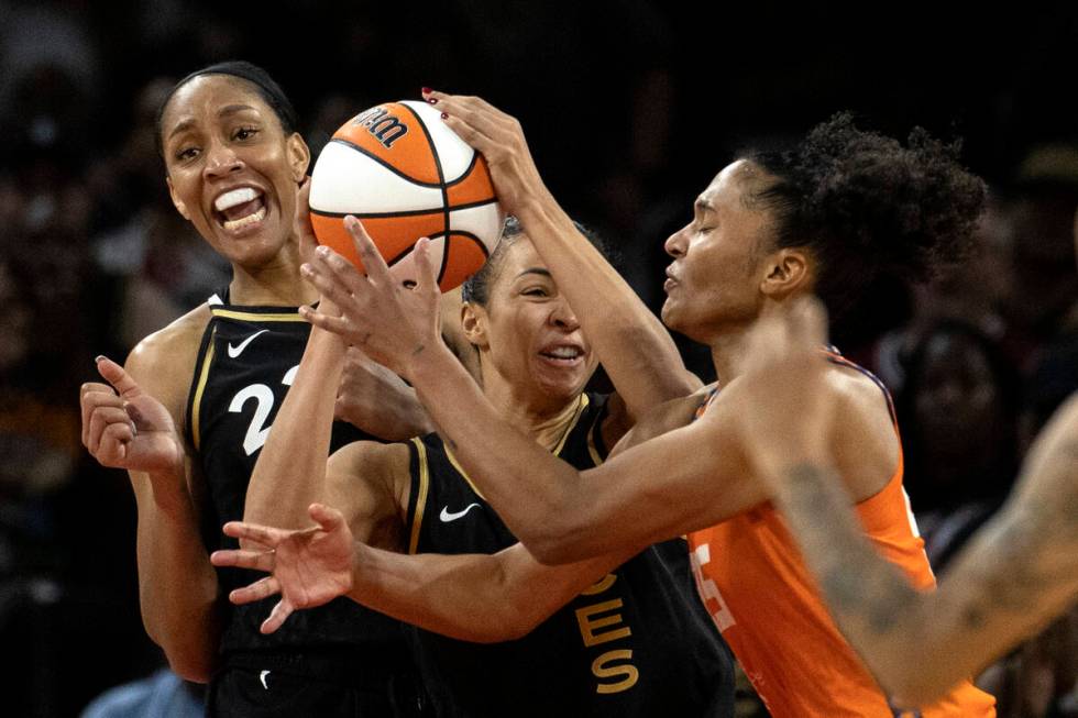 Las Vegas Aces forward A'ja Wilson (22), center Kiah Stokes (41) and Connecticut Sun forward Al ...