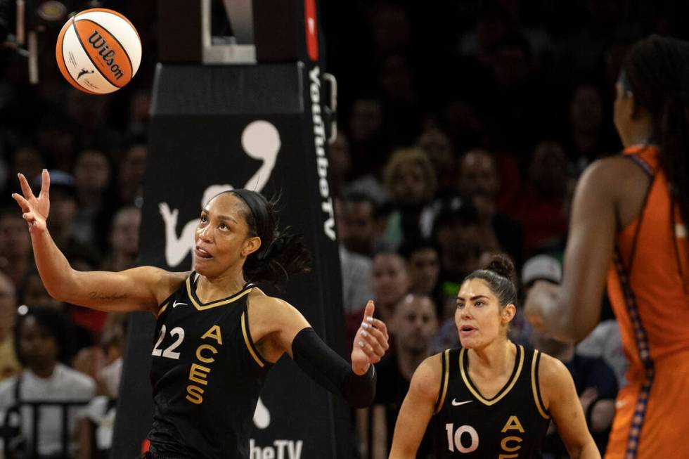 Las Vegas Aces forward A'ja Wilson (22) pivots for the rebound while guard Kelsey Plum (10) and ...