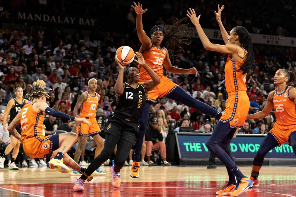 Las Vegas Aces guard Chelsea Gray (12) shoots against Connecticut Sun forward Jonquel Jones (35 ...