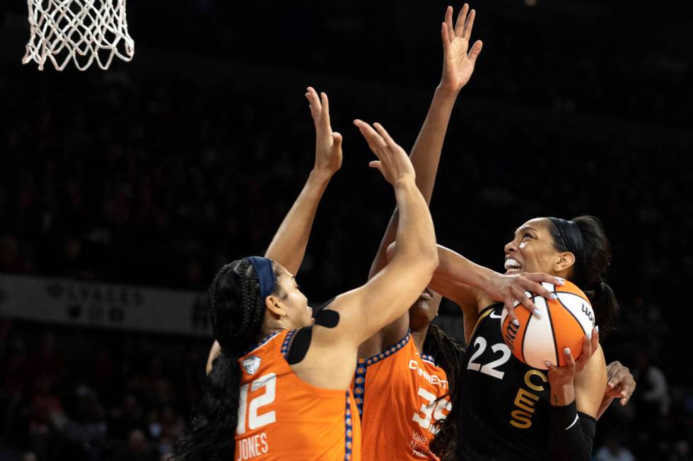 Las Vegas Aces forward A'ja Wilson (22) shoots against Connecticut Sun center Brionna Jones (42 ...