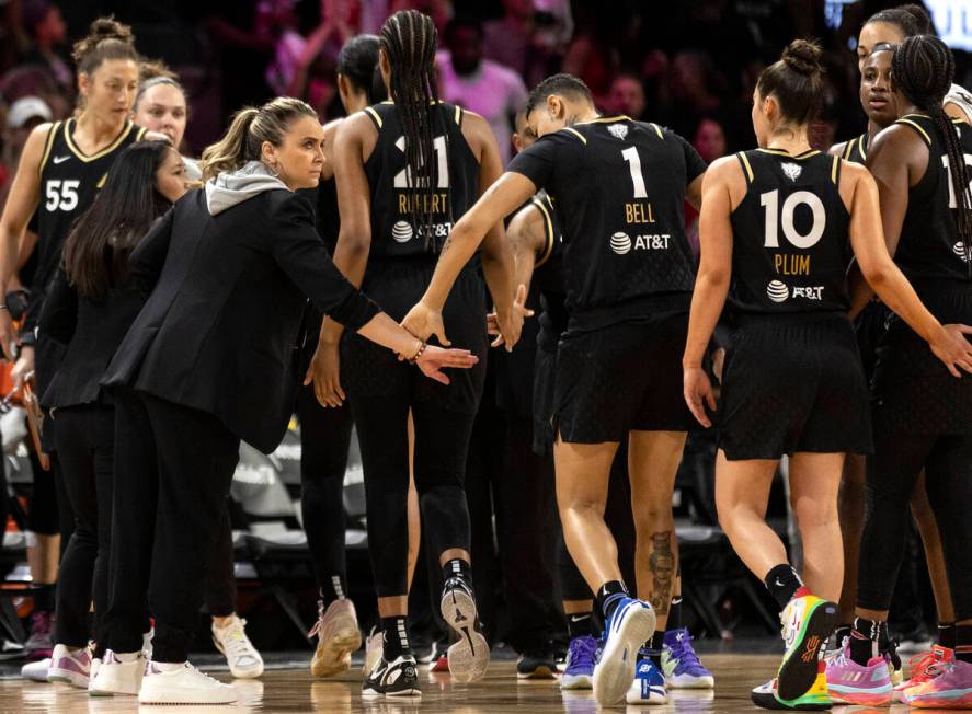 Las Vegas Aces head coach Becky Hammon slaps hands with her team before rotating the starters o ...