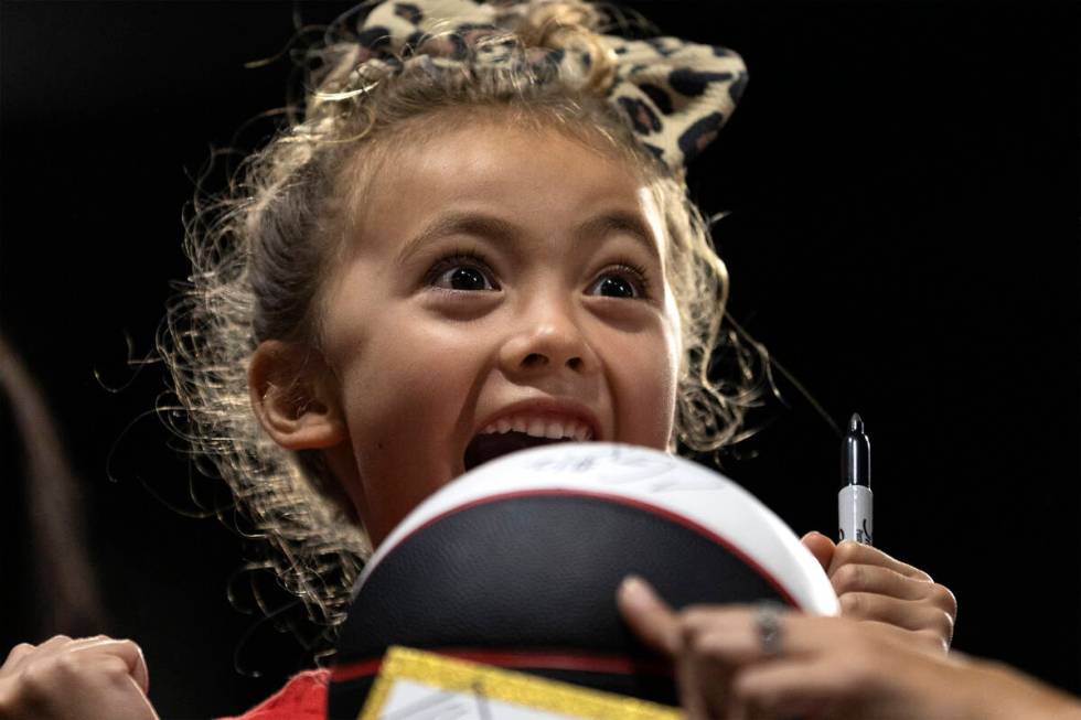 Layne Thompson, 5, of South Carolina, screams after Las Vegas Aces forward A'ja Wilson signed h ...