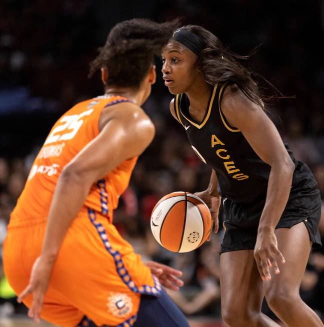 Las Vegas Aces guard Jackie Young (0) looks for an opening while Connecticut Sun forward Alyssa ...