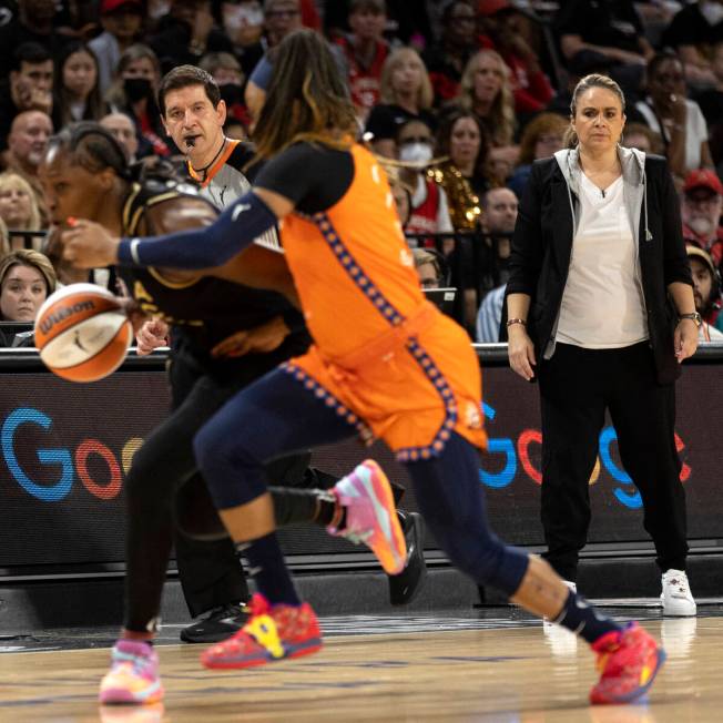 Las Vegas Aces head coach Becky Hammon watches as guard Chelsea Gray (12) drives around Connec ...