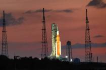 The sun rises behind Artemis I, NASA’s heavy-lift lunar rocket system, as it sits temporarily ...