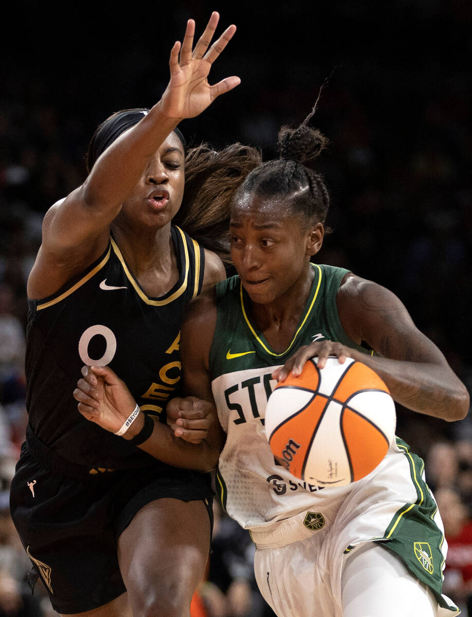 Seattle Storm guard Jewell Loyd (24) drives around Las Vegas Aces guard Jackie Young (0) during ...