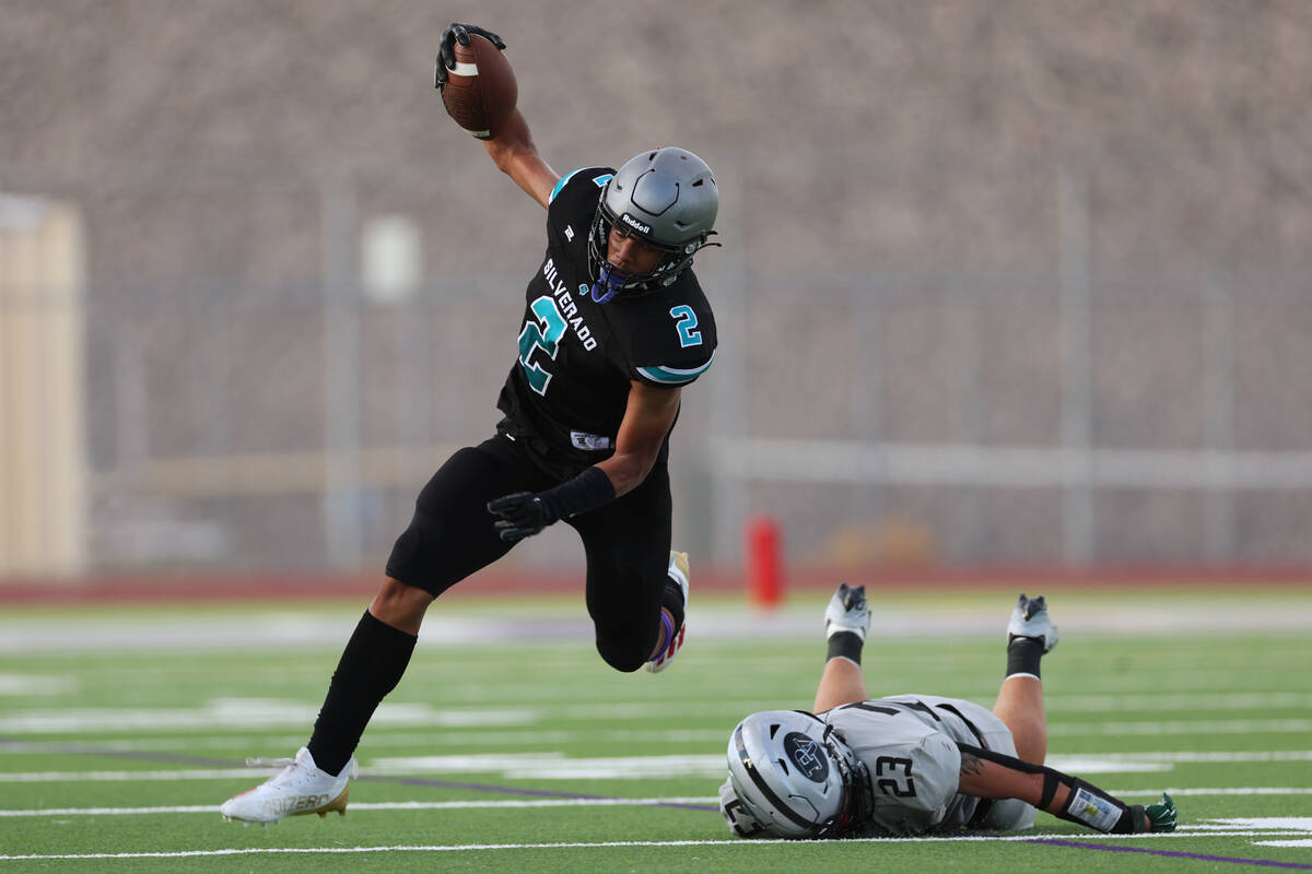 Silverado's Donavyn Pellot (2) dodges a tackle by Palo Verde's Blair Thayer (23) during the fir ...