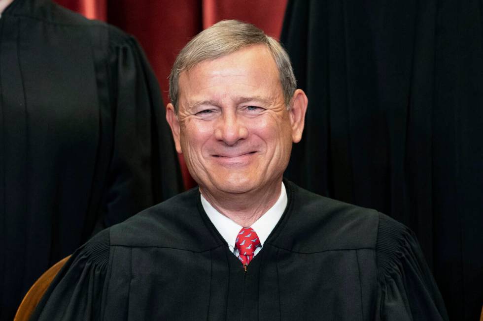 FILE - Chief Justice John Roberts sits during a group photo at the Supreme Court in Washington, ...