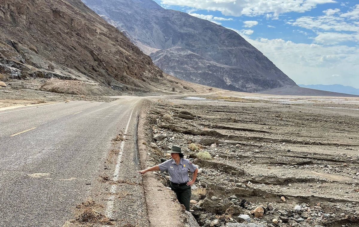 Death Valley National Park spokesperson Abby Wines stands in an eroded shoulder on the side of ...