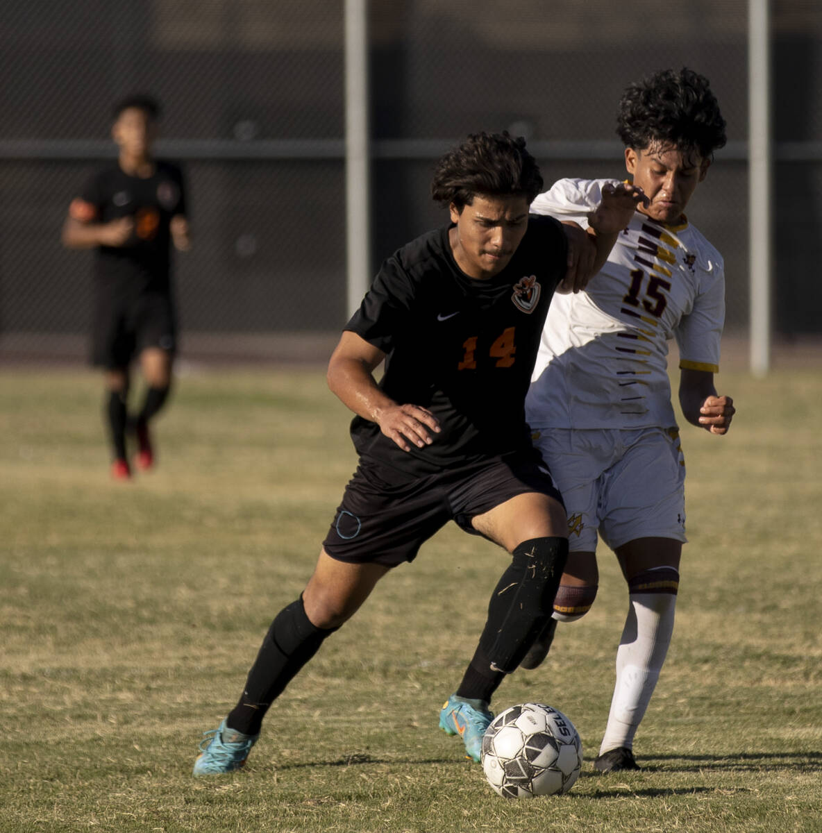 Chaparral's Isaiah Aguilar (14) and Eldorado's Luis Martinez (15) fight for the ball during the ...