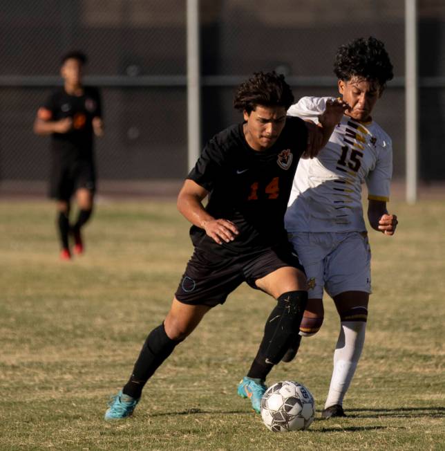 Chaparral's Isaiah Aguilar (14) and Eldorado's Luis Martinez (15) fight for the ball during the ...