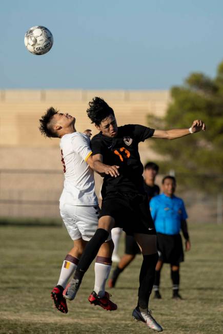 Eldorado's Hugo Gonzalez-Vivian (8) and Chaparral's Diego Cabral (13) go up for a header during ...