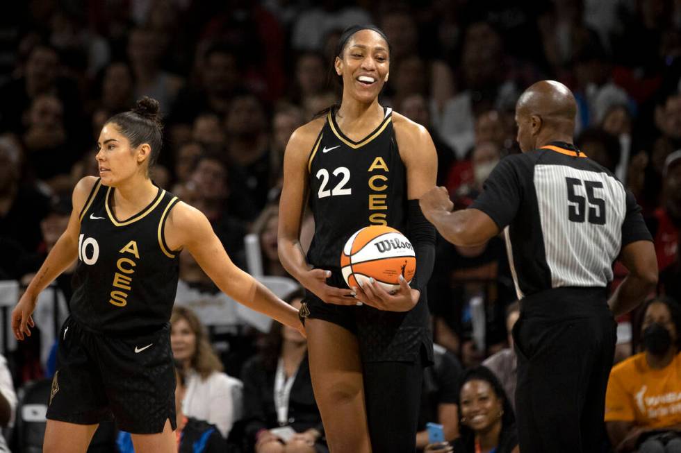 FILE - Las Vegas Aces guard Kelsey Plum (10) pats forward A'ja Wilson (22) after she made an of ...