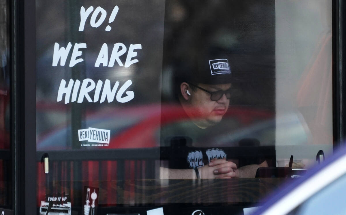 A hiring sign is displayed at a restaurant in Schaumburg, Ill., April 1, 2022. (AP Photo/Nam Y. ...