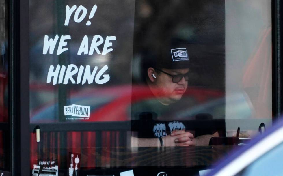 A hiring sign is displayed at a restaurant in Schaumburg, Ill., April 1, 2022. (AP Photo/Nam Y. ...