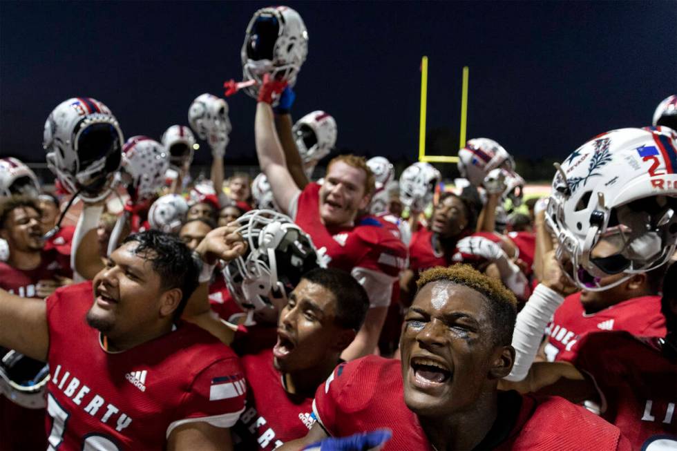 Liberty players go crazy with their student section after winning their Class 5A high school fo ...