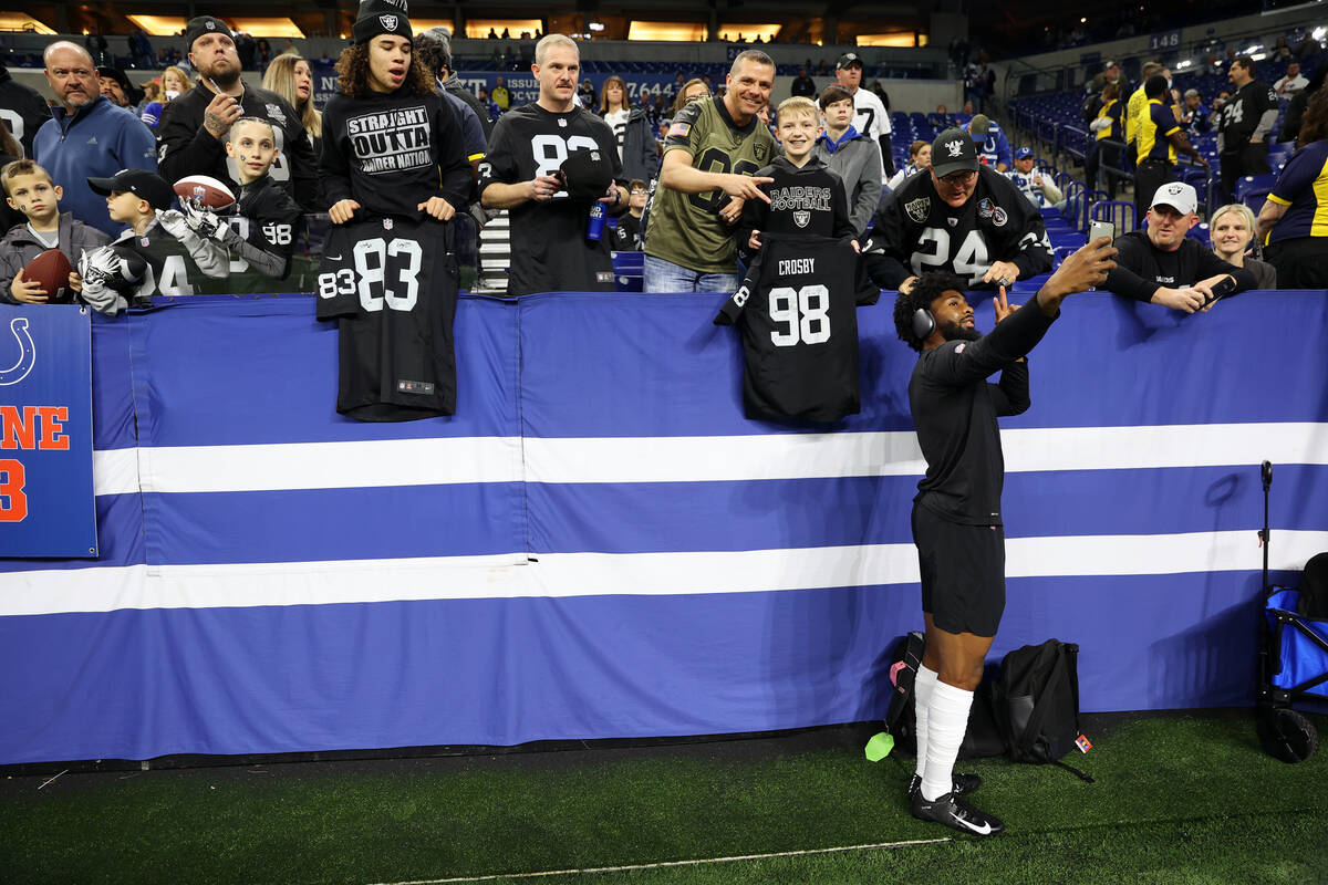 Raiders cornerback Nate Hobbs (39) takes a photo with fans before the start of an NFL football ...