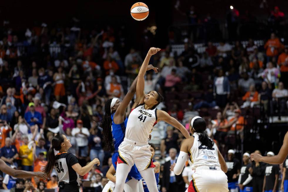 Las Vegas Aces center Kiah Stokes (41) and Connecticut Sun forward Jonquel Jones (35) tip off d ...