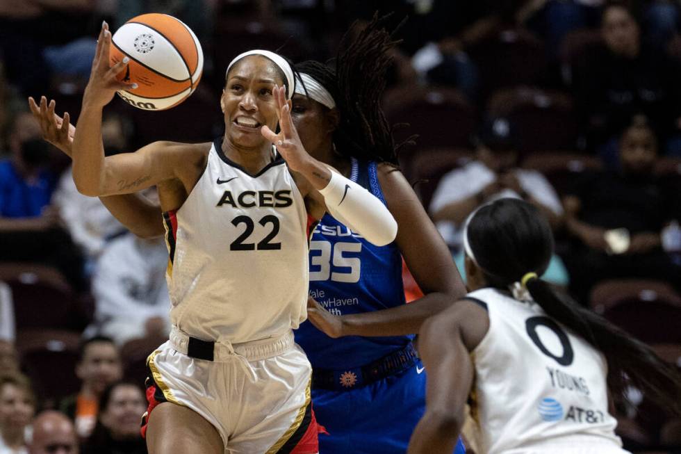 Las Vegas Aces forward A'ja Wilson (22) attempts to maintain possession while Connecticut Sun f ...