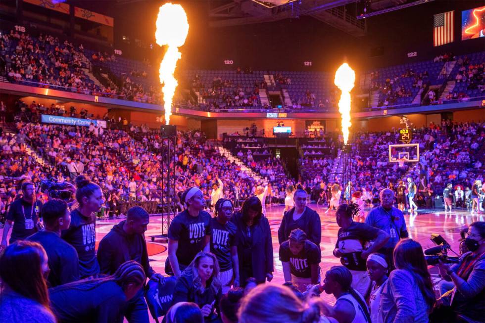 The Las Vegas Aces huddle up as the Connecticut Sun starting lineup is announced before Game 3 ...