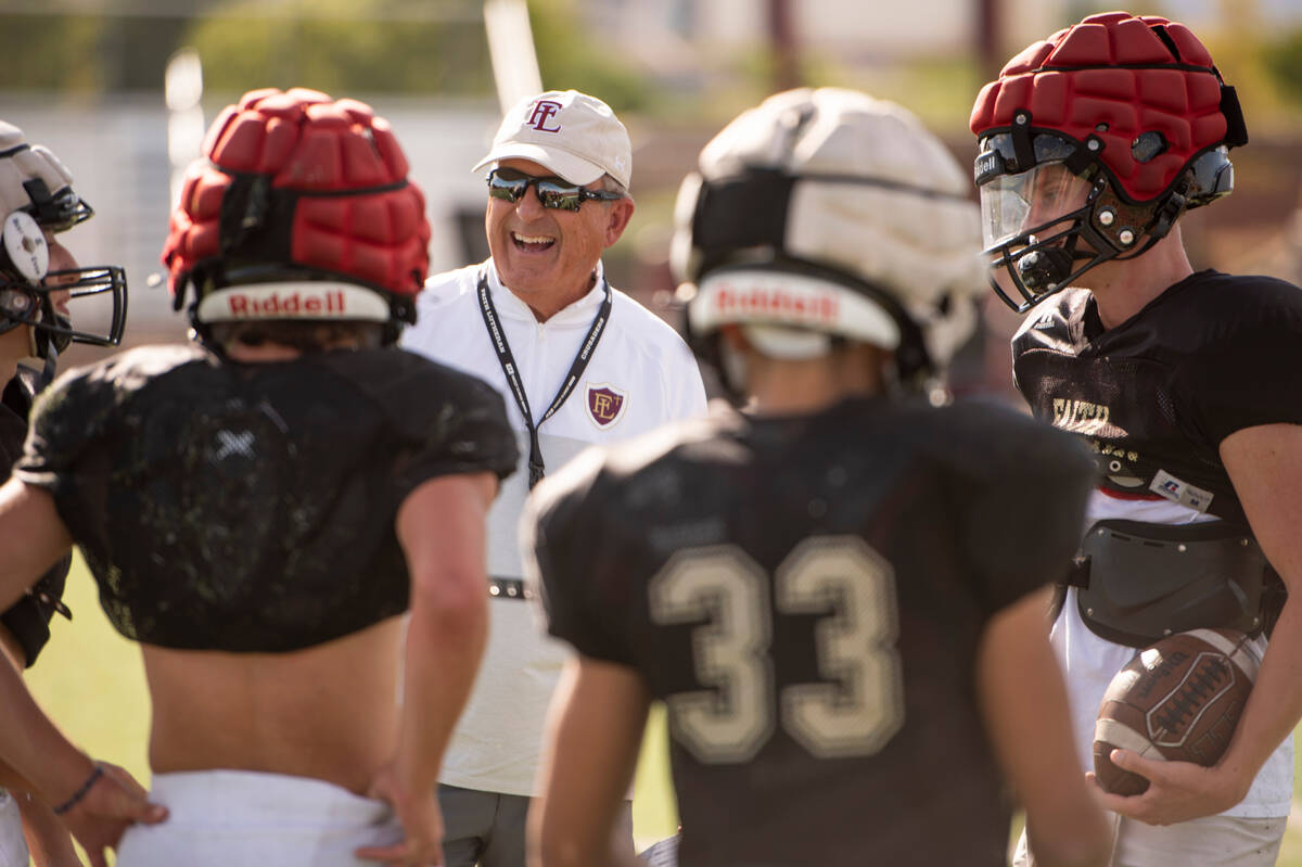 Former UNLV coach, and Faith Lutheran head coach, Mike Sanford laughs with players during pract ...