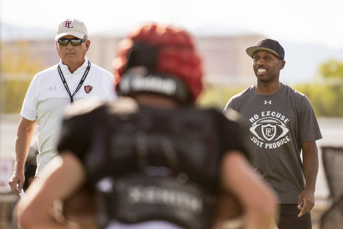 Former UNLV coach, and Faith Lutheran head coach, Mike Sanford, left, leads a drill with assist ...